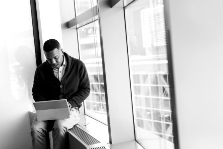 Grayscale Photo Of Man Using Laptop photo