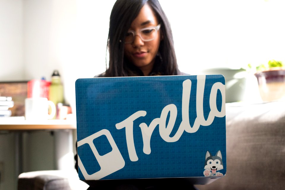 Woman Wearing Eyeglasses Using Blue And And Gray Laptop Inside Room