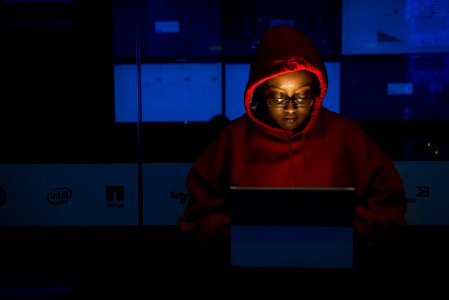 Woman In Red Hoodie Using Gray Laptop Computer photo