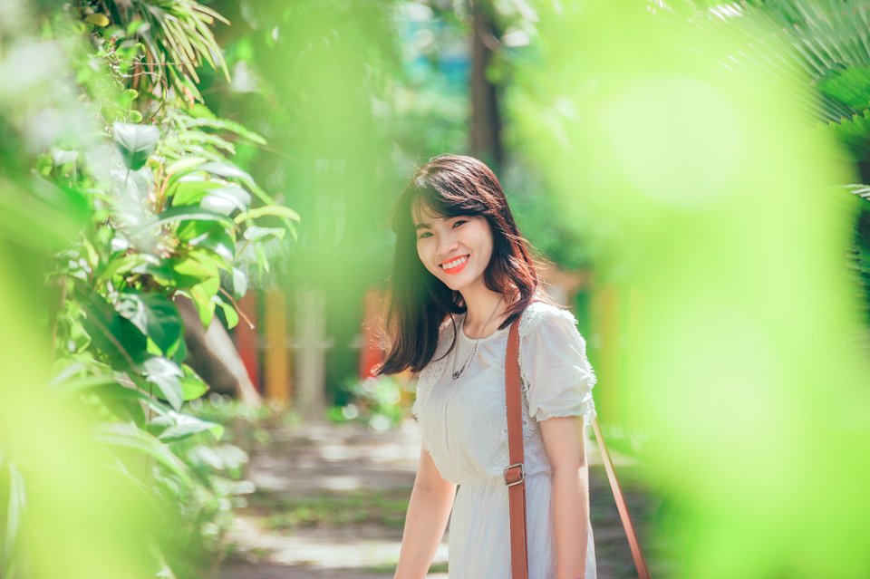 Woman Standing Nearby Green Leafed Plant