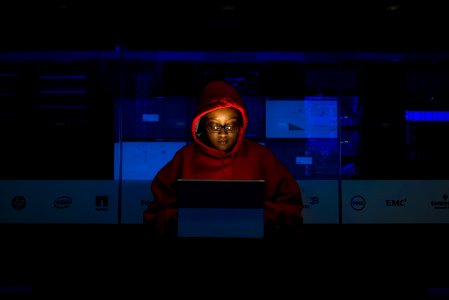 Woman Wearing Hooded Pullover Hoodie Facing Tablet Computer photo