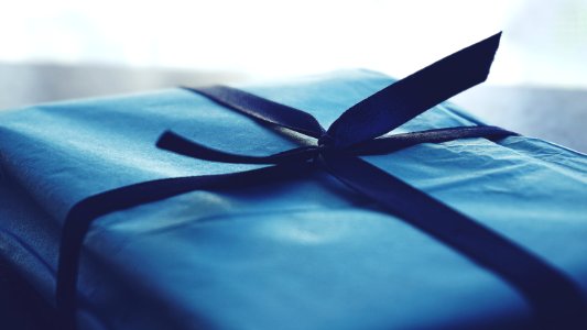 Close-up Photo Of Tied Blue Box