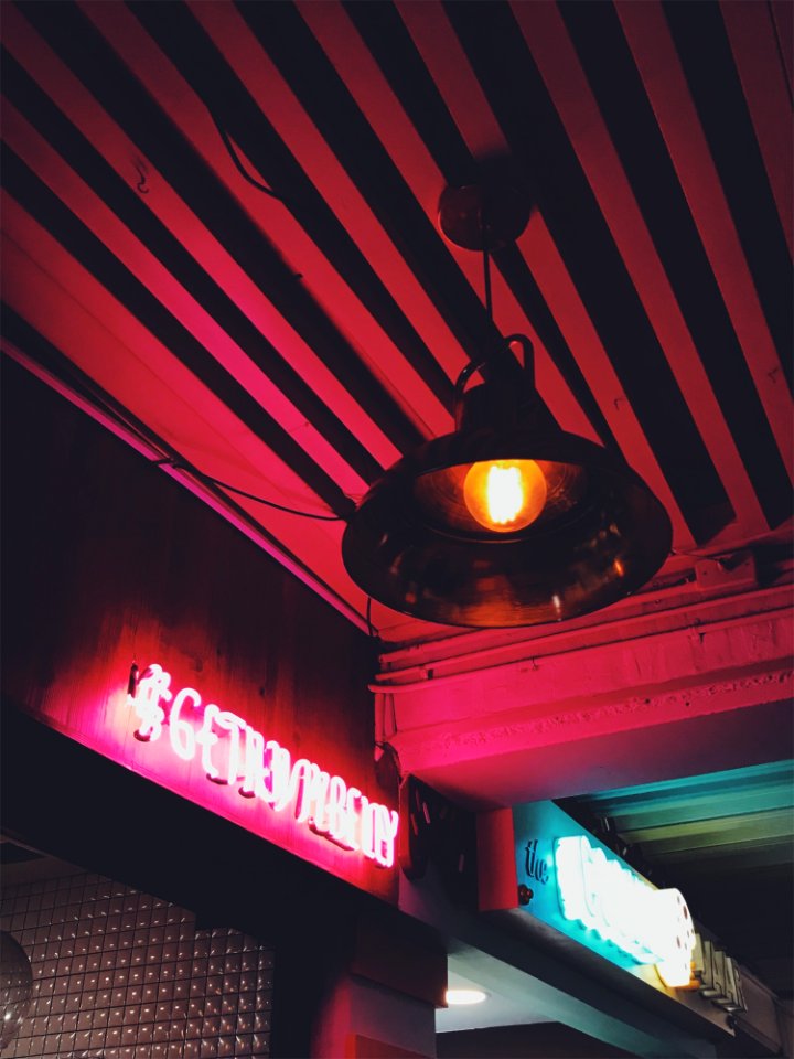 Round Brown Pendant Lamp On Red Ceiling Turned On