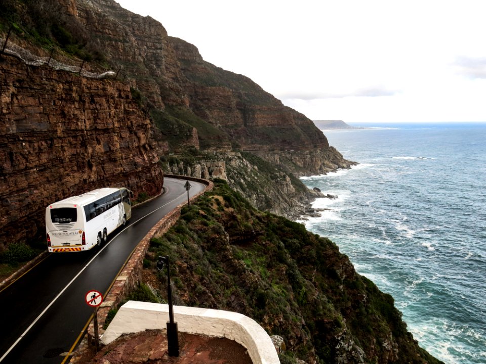 White Bus On Road Near Cliff