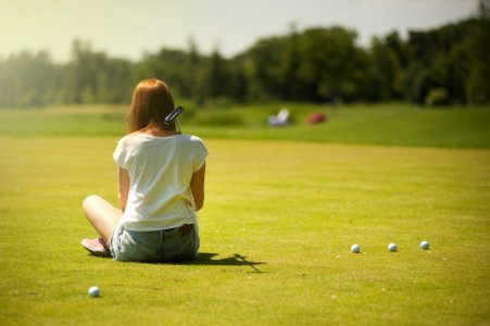 Photo Of Woman Sitting On Grass Field