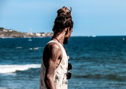 Man In White Tank Top On Seashore photo