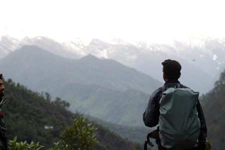 Man With Gray Backpack Across Mountain photo