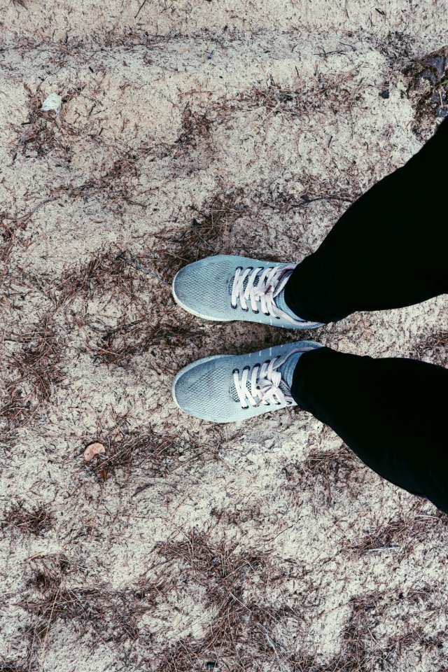 Person In Black Pants And Pair Of Blue Sneakers