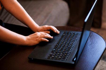 Person Working On Black Laptop photo