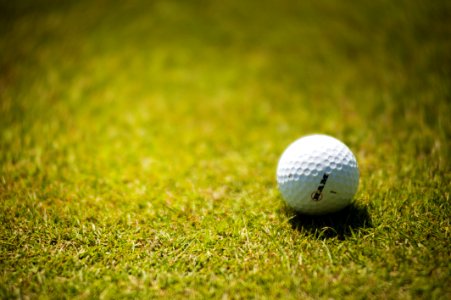 White Golf Ball On Green Grass photo