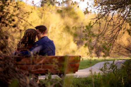 Photography Of Couple Sitting On Bench photo