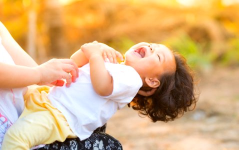 Person Carrying Child Wearing White Top photo