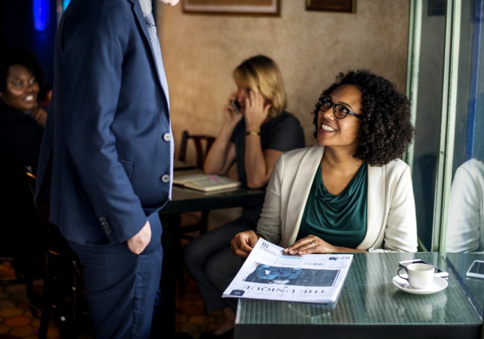 Man In Blue Suit Jacket In Front Of Woman Sitting Near Window