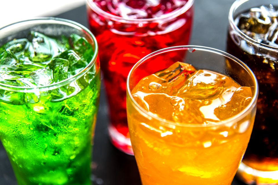 Four Clear Drinking Glasses Filled With Beverages