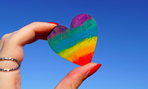 Person Holding Multicolored Heart Decor photo
