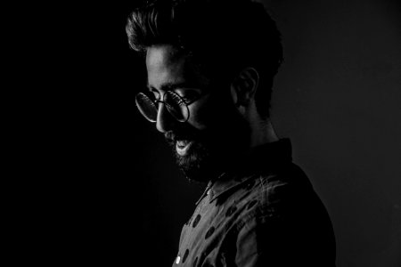 Grayscale Photography Of Man Wearing Round Eyeglasses photo