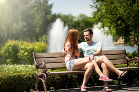 Man And Woman Sitting On A Bench photo