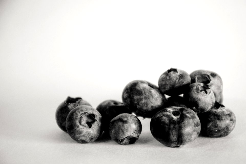 Grayscale Photography Of Blueberries