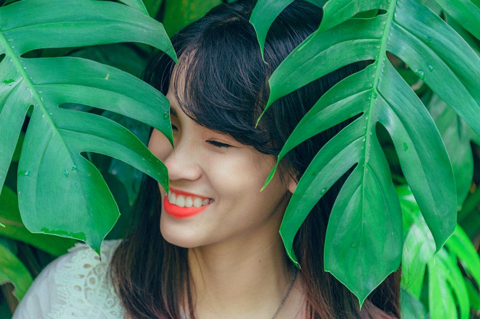 Close-Up Photography Of Girl Near Leaves