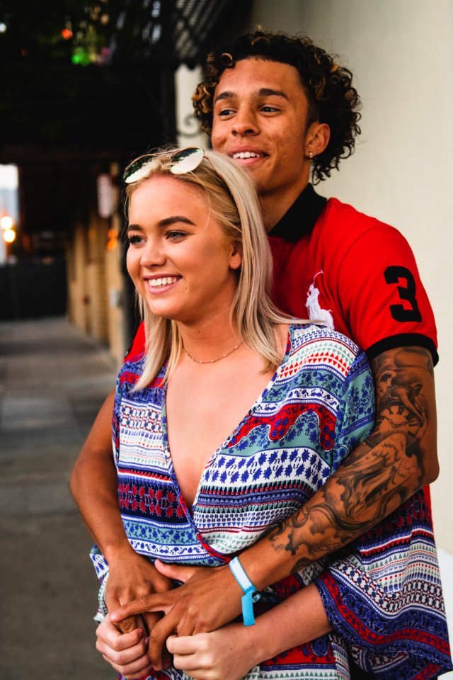 Woman Standing Infront On Man Hands Over Arm
