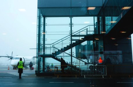 Photo Of Glass Building Near Airplane photo