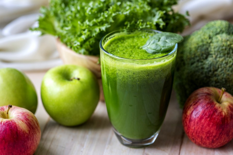 Green Liquid Fruit Juice On Glass Beside Apples