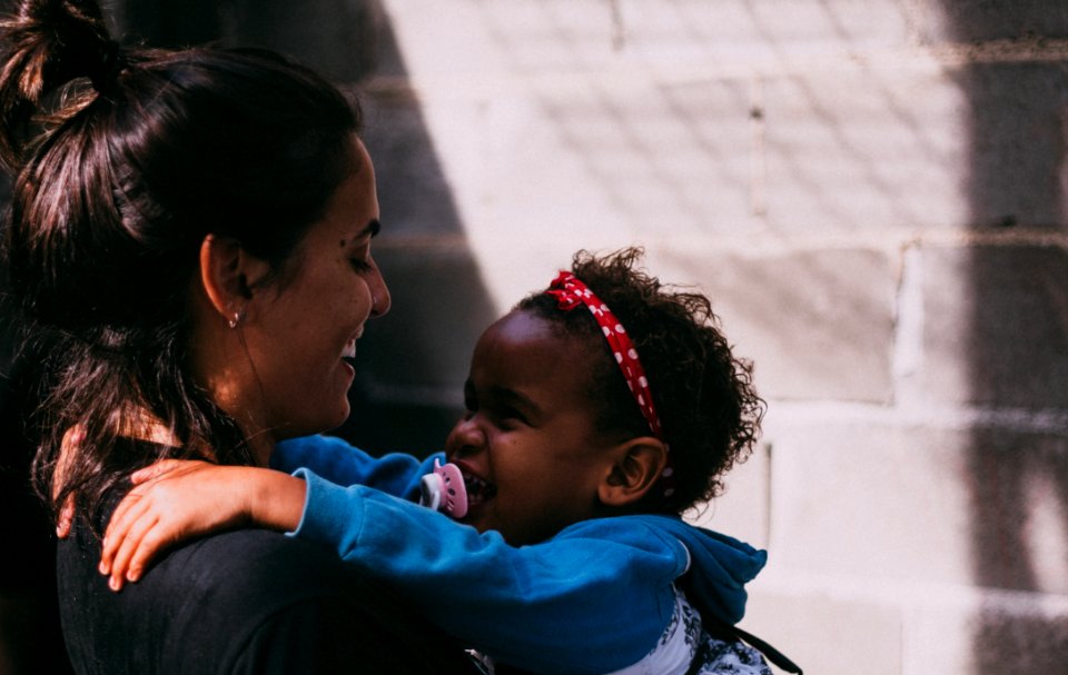 Woman Holding Baby Wearing Blue Jacket