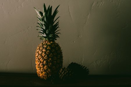 Pineapple Fruit Near Pine Cones photo