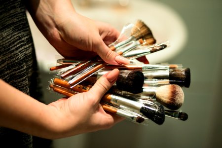 Person Holding Makeup Brushes photo