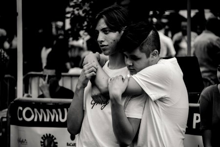 Grayscale Photography Of Man Hugging Each Other