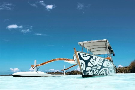 White And Blue Wooden Canoe Under Blue Sky At Daytime photo