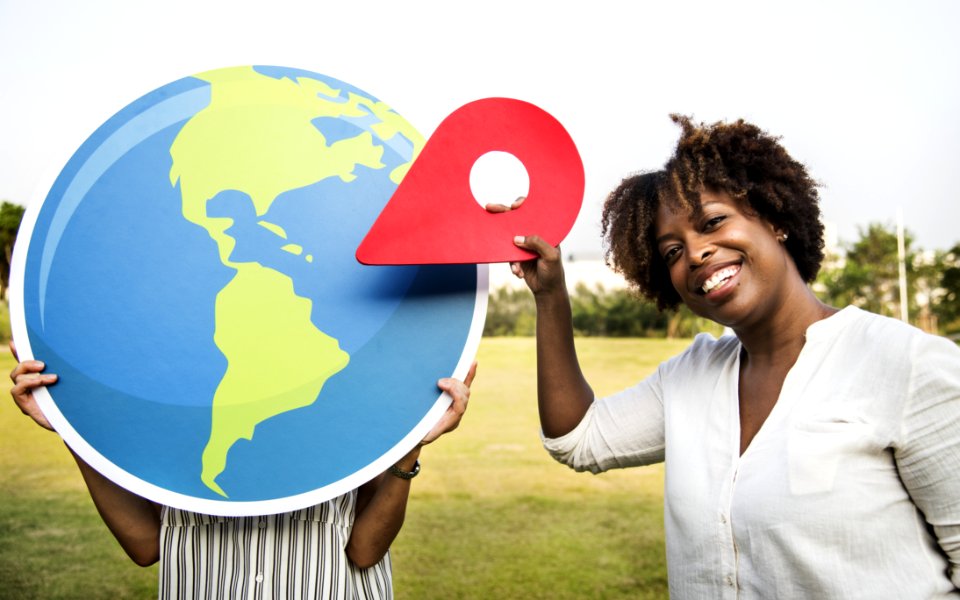 Woman Holding Plastic Arrow While Smiling