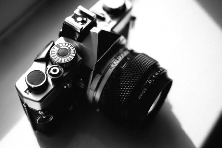 Black And Gray Dslr Camera On White Surface photo