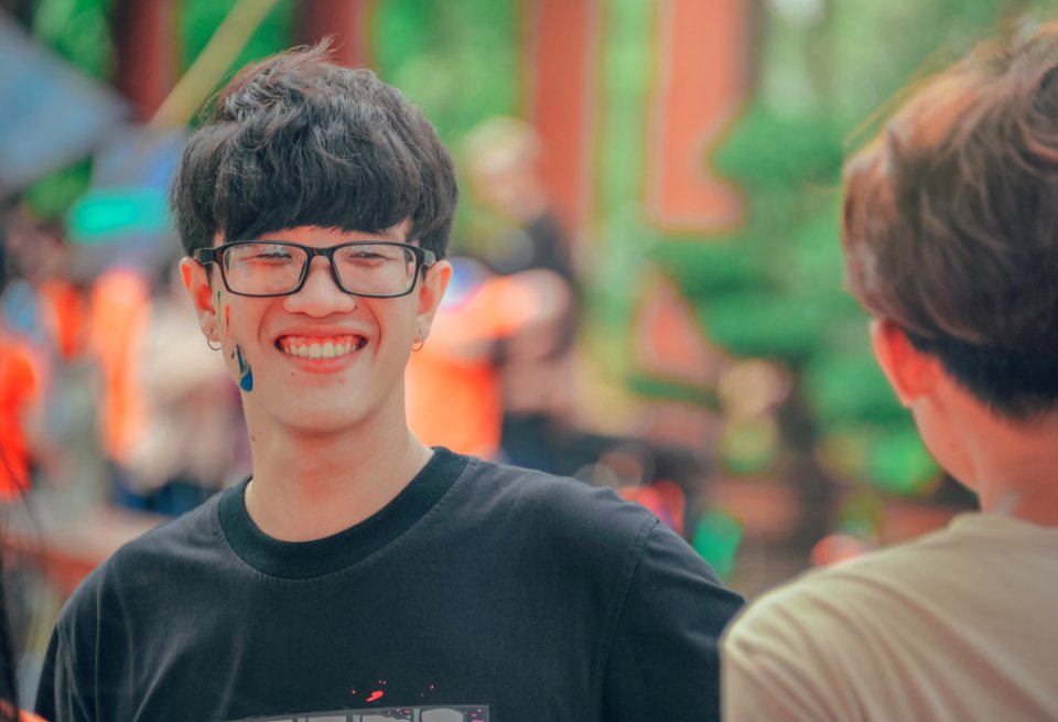 Smiling Man In Black Shirt Wearing Eyeglasses