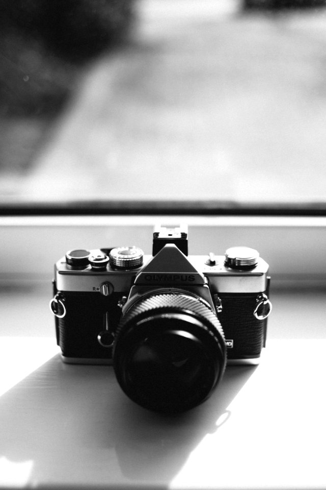 Grayscale Photography Of Olympus Dslr Camera Near The Mirror