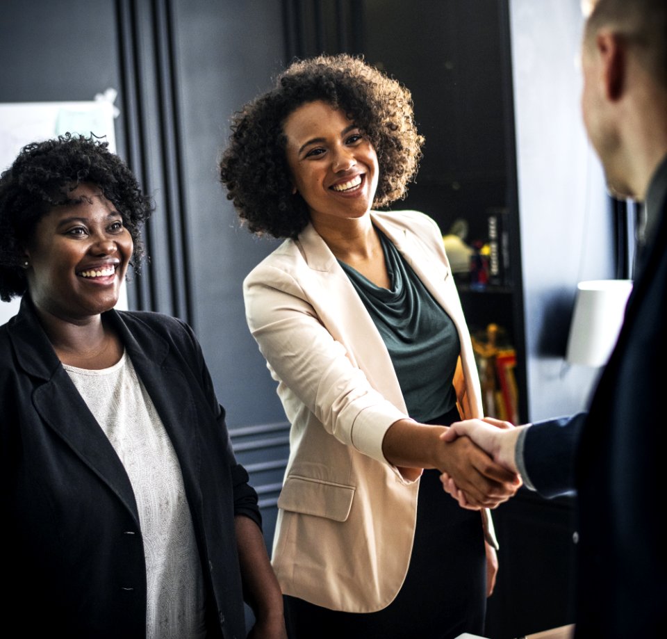 Woman Wears Beige Suit Hand Shaking Man Wear Suit