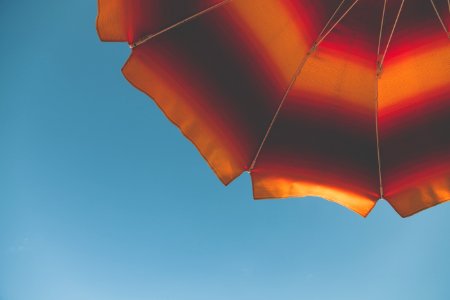 Low Angle Photography Of Black And Orange Beach Umbrella photo