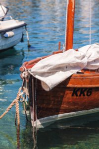 White Textile On Brown Boat