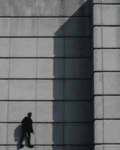 Photo Of Man Standing On Concrete Building photo