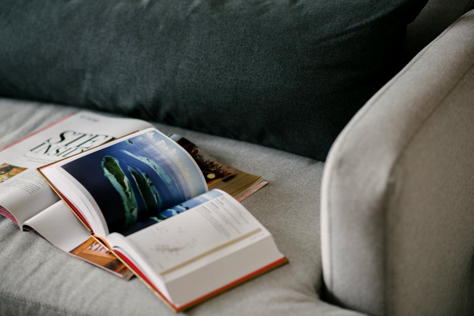 Red And White Reading Book On Gray Textile