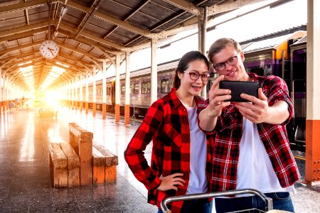 Man And Woman Taking Selfie Near Gray Train photo