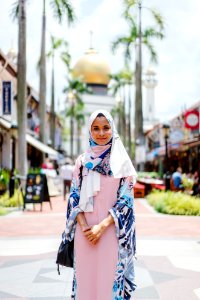 Woman Wearing Hijab And Abaya Dress While Standing With Mosque As Background