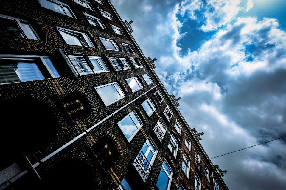 Brown Concrete Building Under Blue And White Cloudy Sky photo