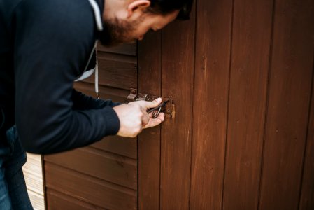 Man In Black Pullover Jacket Picking Lock photo