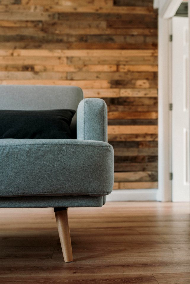 Gray Fabric Sofa Near White Wooden Wall
