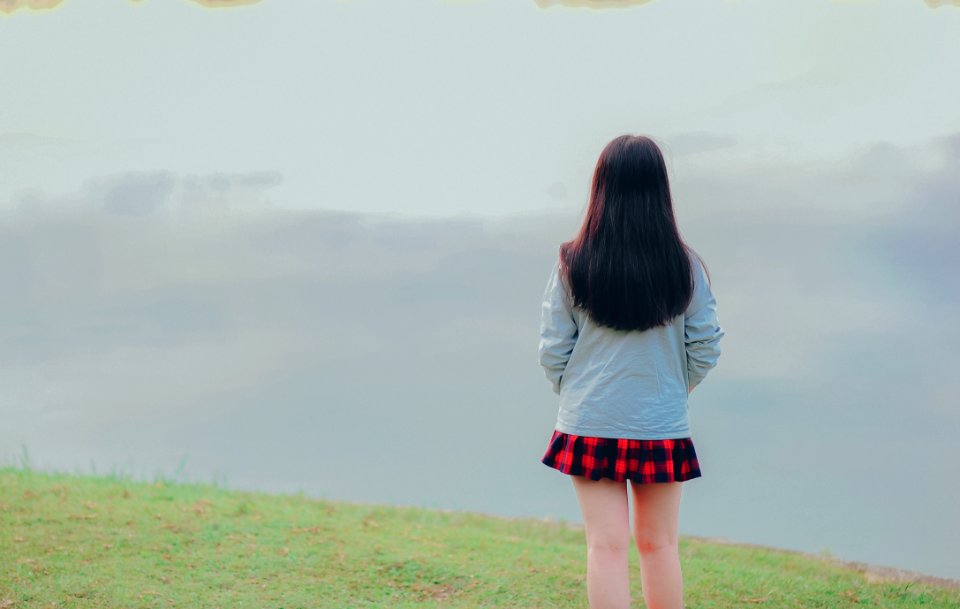 Woman Standing Wearing White Long-sleeved Top