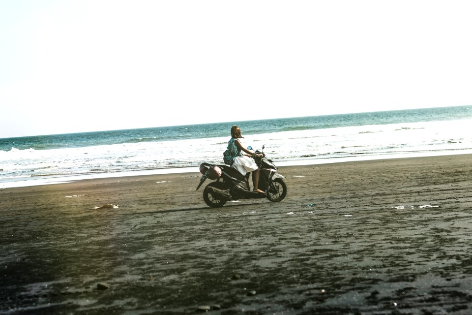Man Riding Black And Gray Motor Scooter On Beach