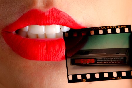 Person Wearing Red Lipstick Biting Film