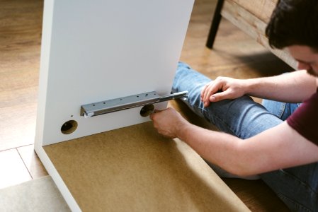 Photo Of Man Assembling Furniture photo