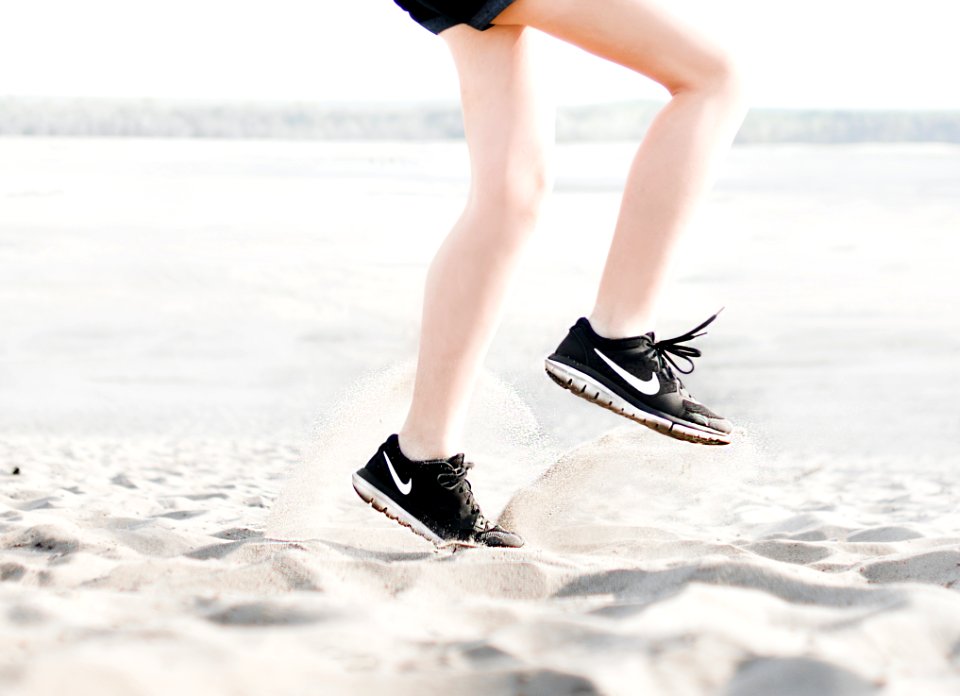 Photo Of Woman Wearing Pair Of Black Nike Running Shoes